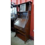 An Arts and Crafts walnut bureau bookcase