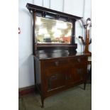 An Arts and Crafts mahogany mirrorback sideboard