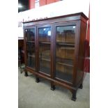 An Arts and Crafts mahogany three door bookcase