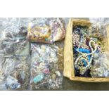 A large box of vintage costume jewellery; earrings, pendants, necklaces, etc.