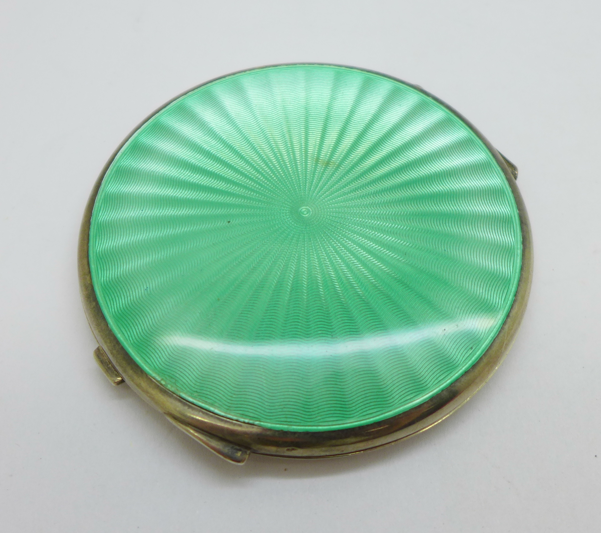 A silver and green enamel compact, Birmingham 1948, Mappin & Webb, (a/f, dent on the underside)