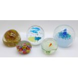 Five glass paperweights including one Caithness