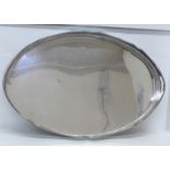 A large oval silver plate on copper gallery tray, 61cm x 40cm