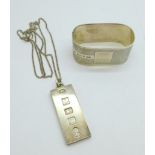 A silver napkin ring and a silver ingot pendant and chain, 56.9g