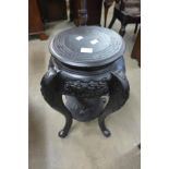 A Chinese carved ebonised jardiniere stand