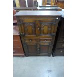 A 17th Century style carved oak side cabinet