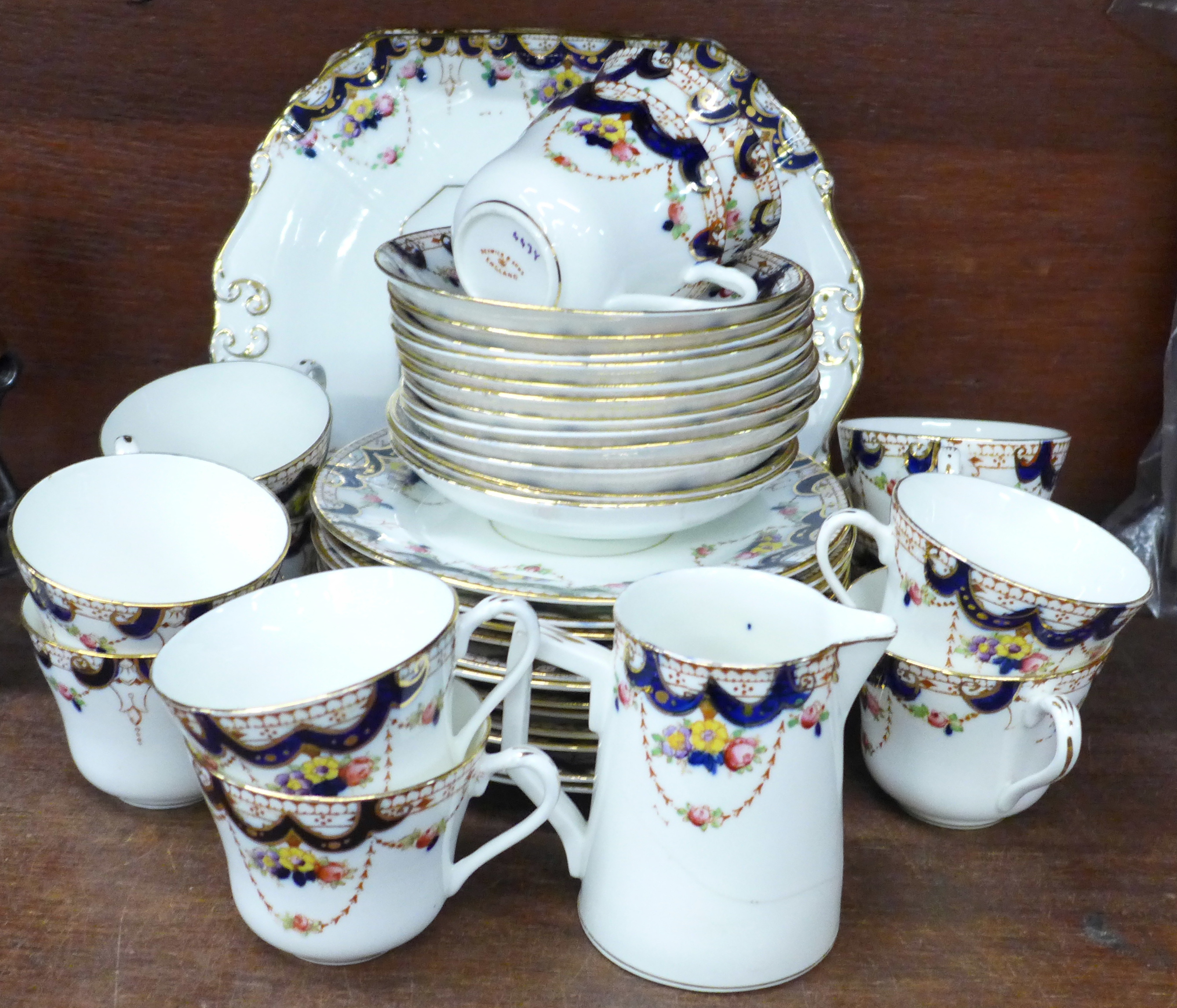 A Beswick & Sons twelve setting tea service, twelve cups, saucers, side plates, two cake plates