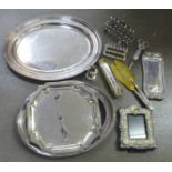 A plated frame, two plated toast racks, a pair of candle snuffers and tray, two servers, silver