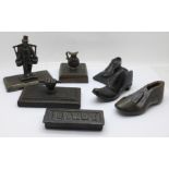 Six novelty cast iron and cast metal desk paperweights and a small shoe last