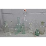 Four glass chemist's bottles and a collection of advertising bottles including Henry Dickins,