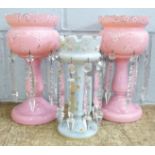 A pair of pink glass lustres, one top chipped and a pale blue glass lustre