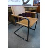 A black tubular steel and brown leather cantilever armchair