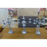 A set of three plated candelabra