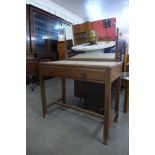 An Art Deco walnut two drawer dressing table, manner of Heals, London