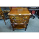 A George III style mahogany two drawer serpentine night stand