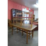 A teak extending dining table and four chairs