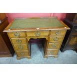 A George III walnut and green leather topped kneehole desk