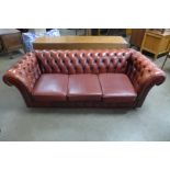 A red leather Chesterfield settee