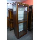 A mid 20th Century oak single door shop display cabinet