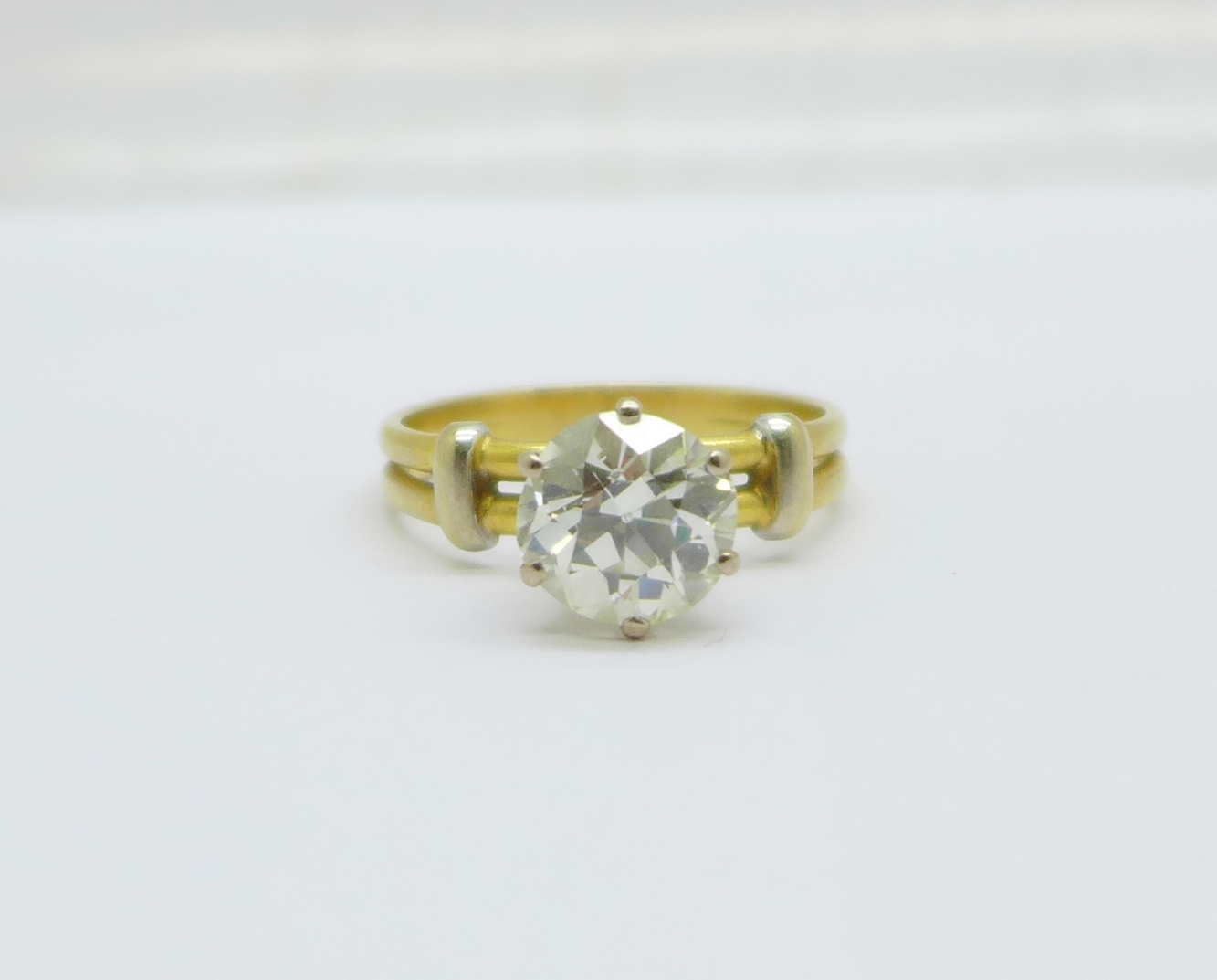 A solitaire diamond ring, approximately 3.3carat weight, set in yellow metal