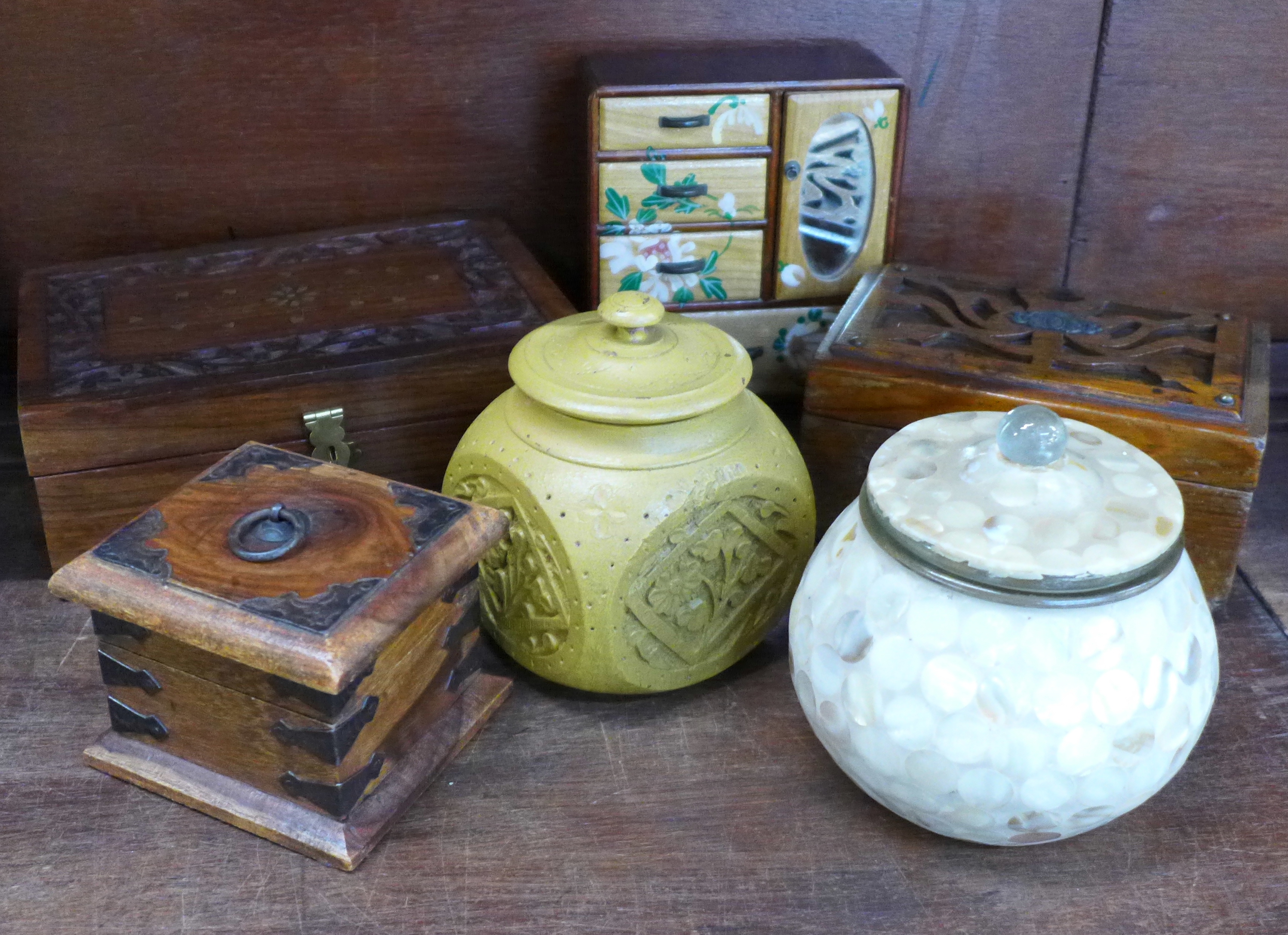 Three wooden boxes, a small chest and two lidded jars