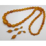A large amber necklace, 94g, largest bead 29mm, 80cm, and a pair of drop earrings lacking hooks
