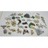 Thirty-two costume brooches including a lucite Erstwilder koala