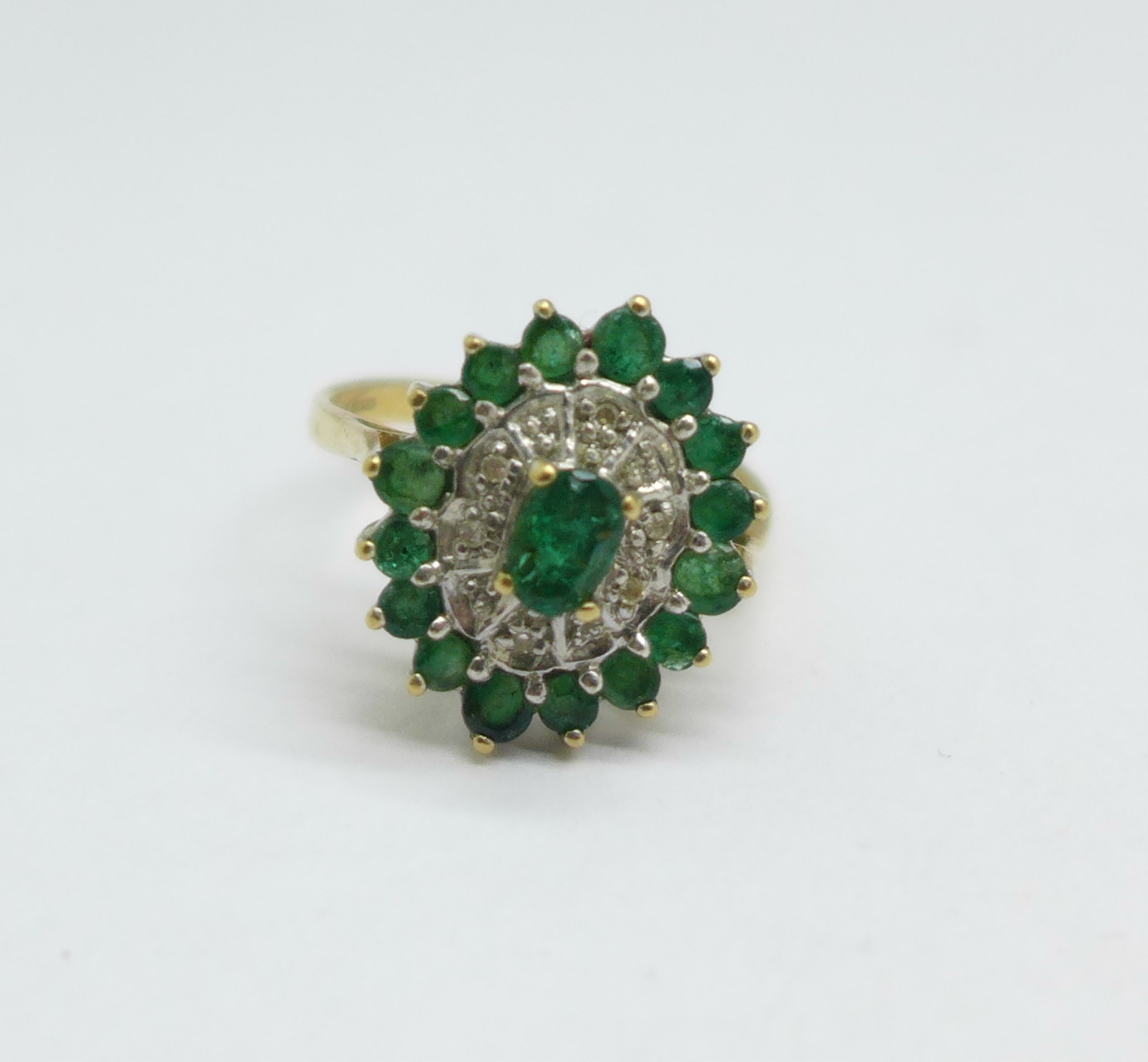 A 9ct gold, emerald and diamond cluster ring, 3.3g, O