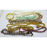 A collection of costume bead necklaces including Bakelite and mother of pearl