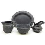 Four pieces of black basalt; two jugs, one a/f, sugar bowl and oval plate