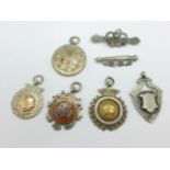 Three silver football fob medals, one with gold applied decoration and two enamelled,