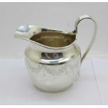 A silver cream jug, London 1911, 115g