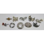 Ten silver brooches including a dragon and a cherub