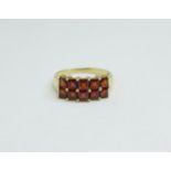 A 9ct gold ring set with red stones, 2.7g, P