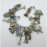 A silver charm bracelet with a Victorian silver cross pendant, an Edwardian silver cross pendant,