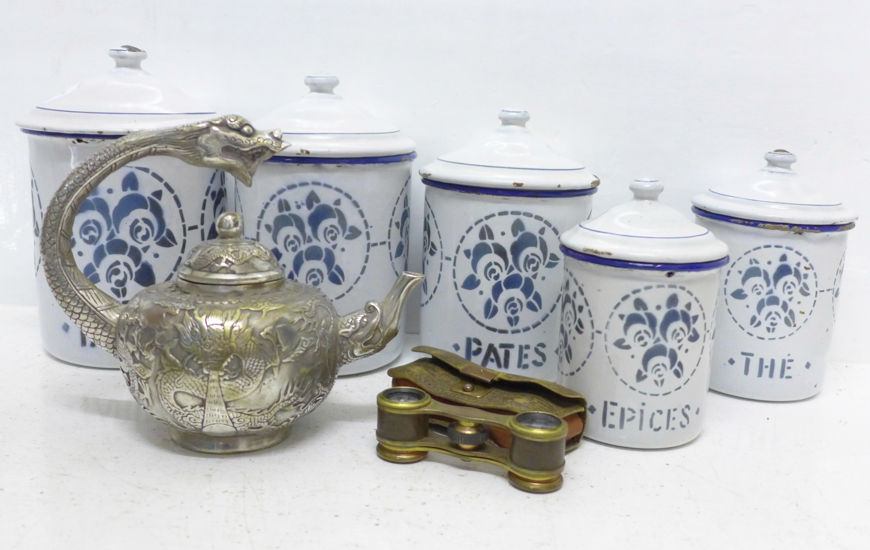 A set of five graduated enamel storage jars, a pair of theatre glasses and an oriental metal teapot