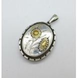 An early 20th Century white metal locket, 32mm x 40mm
