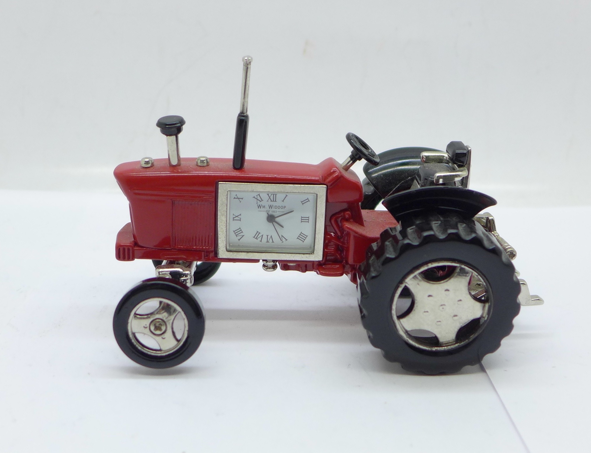 A small novelty desktop tractor set with a timepiece marked William Widdop, length 10cm