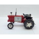 A small novelty desktop tractor set with a timepiece marked William Widdop, length 10cm
