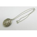 A Victorian locket, tests as silver, on a silver chain