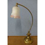 A brass adjustable desk lamp