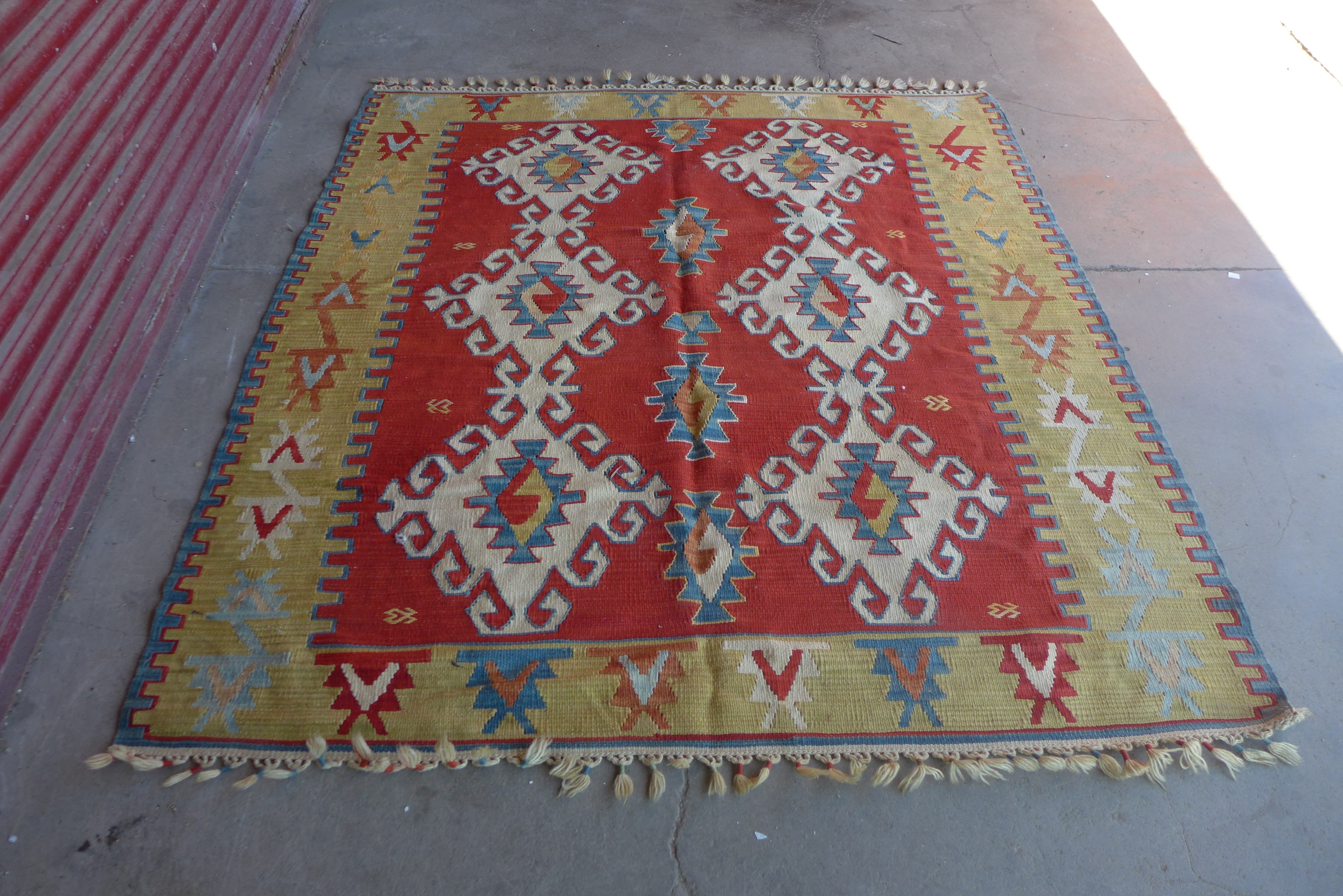 An Eastern red ground kilim rug, 180 x 167cms