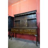 A George III oak dresser, with associated later Delft rack