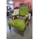 A Victorian Aesthetic Movement carved oak and upholstered armchair
