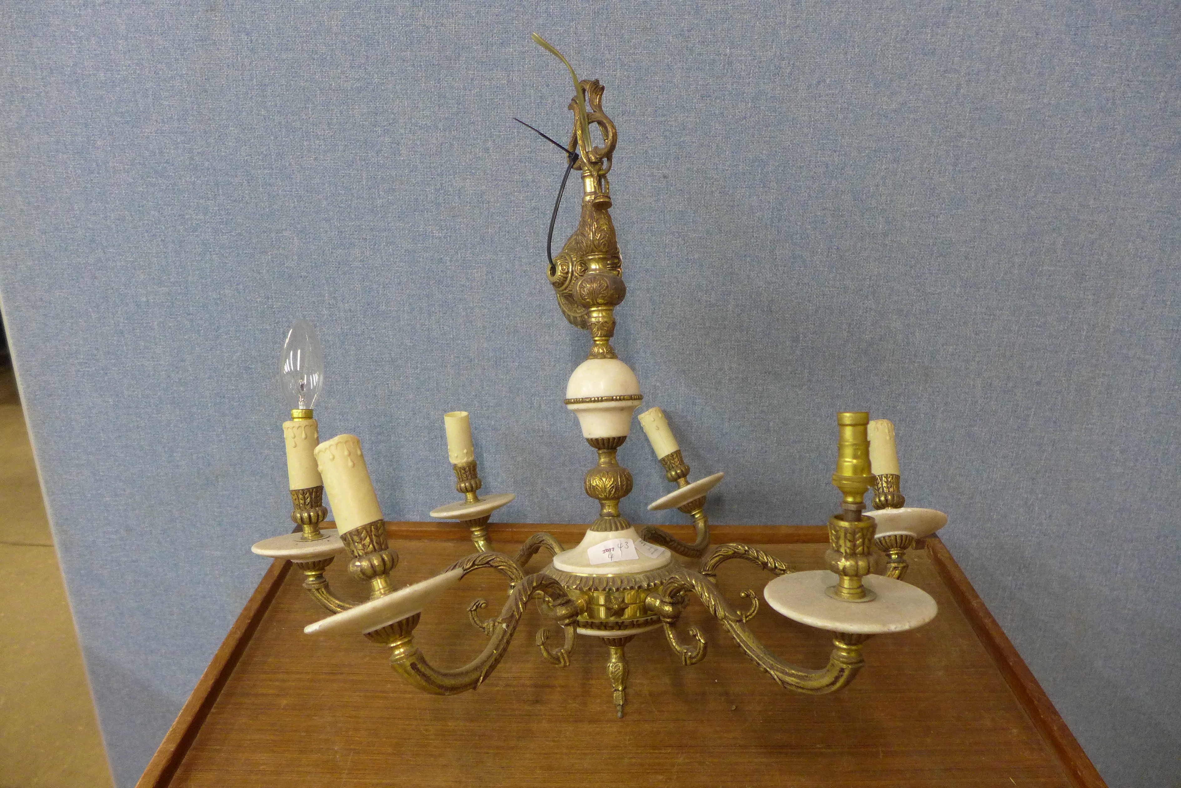A brass and onyx six branch chandelier
