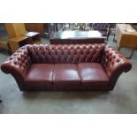 A red leather Chesterfield settee