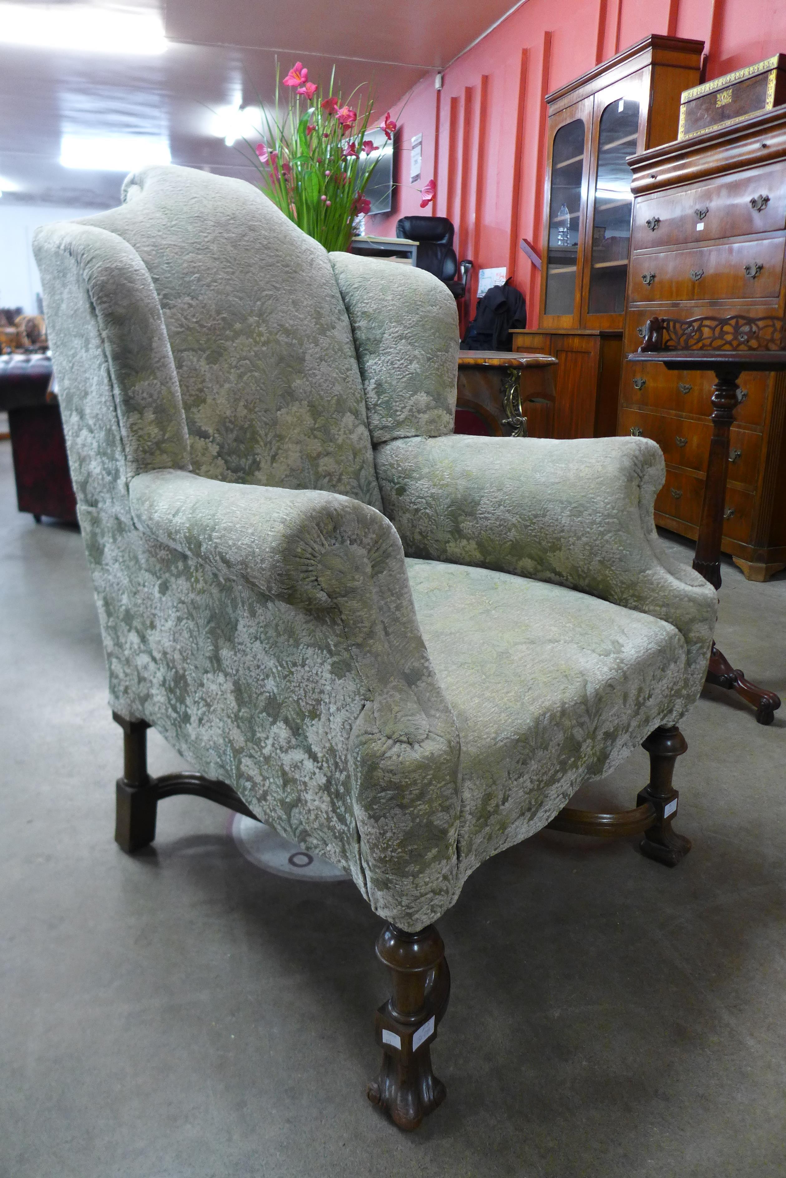An early 20th Century Queen Anne style walnut and fabric upholstered armchair