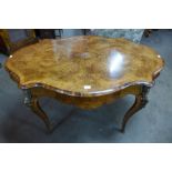 A Victorian figured walnut and gilt metal serpentine centre table