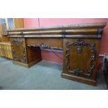 A Victorian carved mahogany pedestal serving table