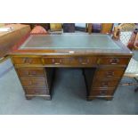 A mahogany and green leather topped pedestal desk